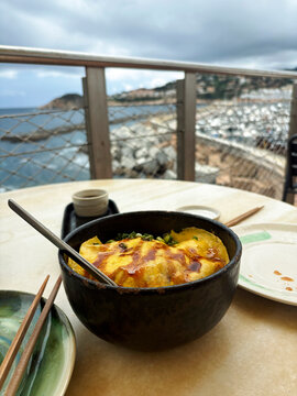 Enjoying a Bowl of Food With a View of the Coast 