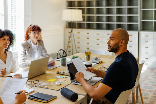 Professionals collaborating discussing new business at workspace
