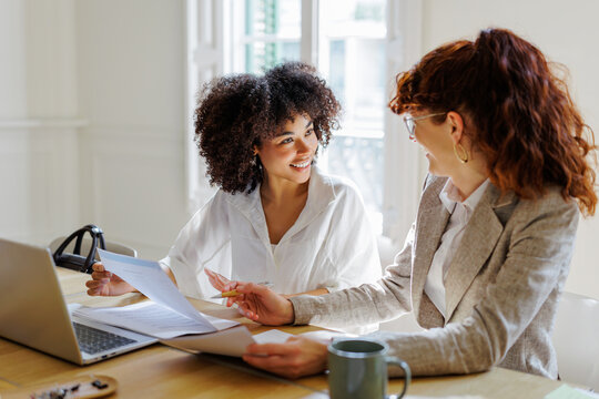 Professionals discussing documents during a business meeting