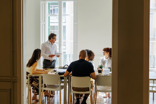 Business team engaged in a meeting, discussing documents and ideas