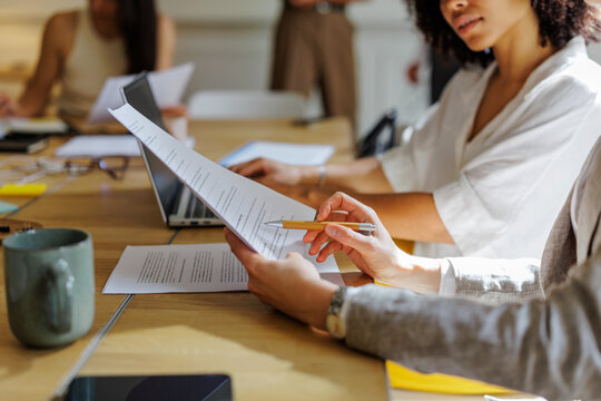 Colleagues reviewing document during a business meeting