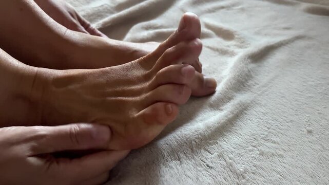 Shiny oiled skin on female foot during a beauty care procedure