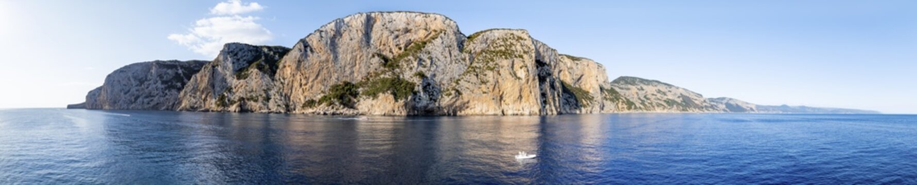 Panorama, motor boat rides in front of picturesque rocky coast ImmorgenLicht, cliffs, Golfo di Orosei, Baunei, Sardinia, Italy
