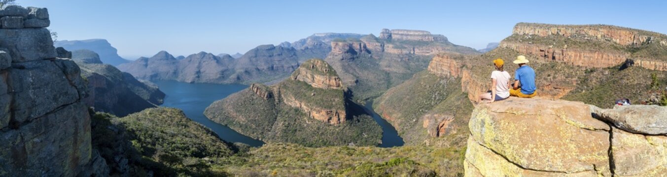 Two hikers enjoying panorama, Blyde River Canyon with Three Rondawels peak, view of gorge with Blyde River and table mountains, canyon landscape, Panorama Route, Mpumalanga, South Africa