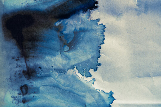 Abstract Blue Ink Spreading on Paper Resembling Hokusai Wave Shape with Uncontrolled Wabi Sabi Style Bleeds
