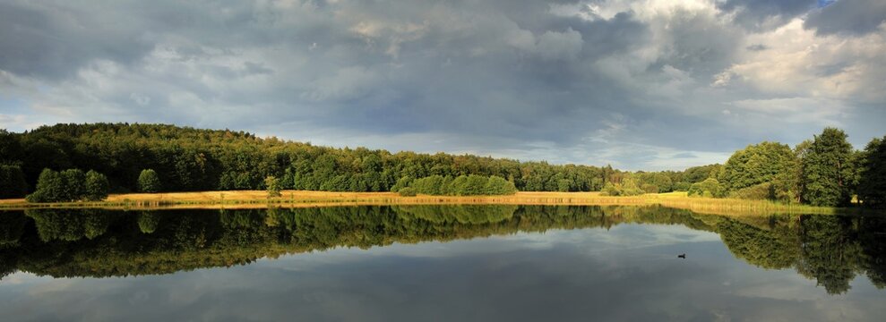 Thunderclouds over pond, near Clausthal-Zellerfeld, Harz Mountains, Lower Saxony, Germany