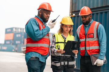 Port worker cargo inspector safety helmet reflective vest clipboard walkie talkie dockyard container yard team logistics port warehouse shipping freight import export supervision inspection safety © chokniti
