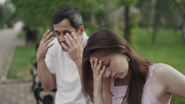 Tired woman ignoring her boyfriend who is aggressively arguing and proving point