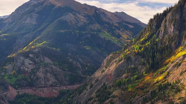 Panoramic aerial view of Mount Abram along Million Dollar Highway in San Juan Mountains Colorado fall landscapes with fall foliage trees in autumn season during morning light -  4K Drone