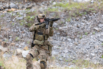 Fototapeta premium Military participate in a patrol in a rocky terrain
