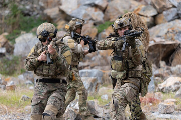 Fototapeta premium Military participate in a patrol in a rocky terrain