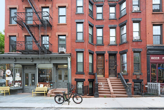 New York City, old apartment building with stores on the ground floor