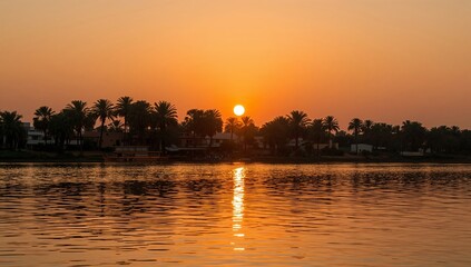 Fototapeta premium Sunset Over a Lake With Palm Trees in the Background and Reflections in the Water