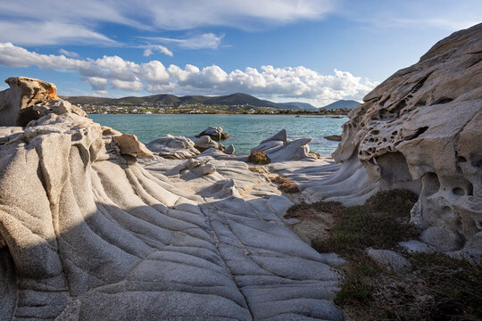 Unique rock formations by the Aegean sea at the Kolymbithres Beach on Paros island in Greece on a sunny day.