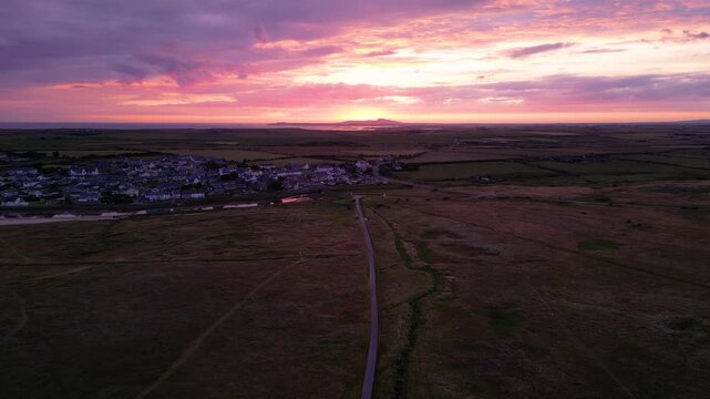 Sunset over coastal village on Anglesey north Wales.