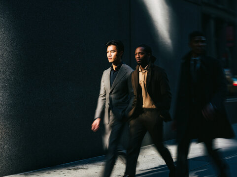 Two Business Professionals Walking Together in Urban Alley