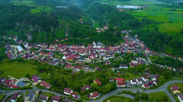 Panoramic aerial view of the old town beside the city Pottenstein in Germany, Baden-W&uuml;rttemberg on a cloudy day in Spring