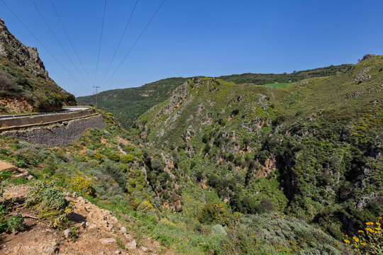 Scenic view of the lush, steep and tall mountains at the Topolia Gorge in Crete, Greece, on sunny day from above.