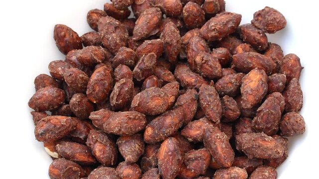 homemade jaggery cocoa-coated almonds served in a white bowl, showcasing a healthy and flavorful nut snack