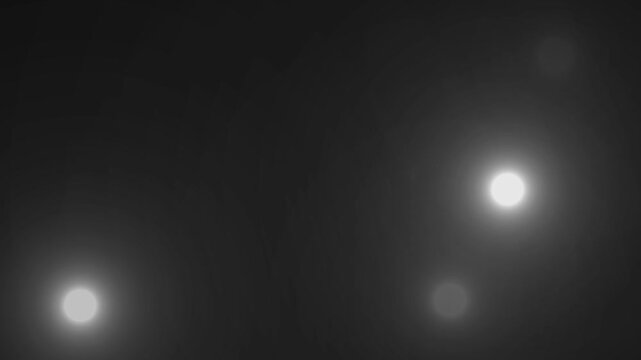 Paparazzi flashes of cameras on a black background. Camera flashes light animation overlay. Cinematic random bright blinking lights. The concept of popularity- Flashing lens flares seamless looping. 