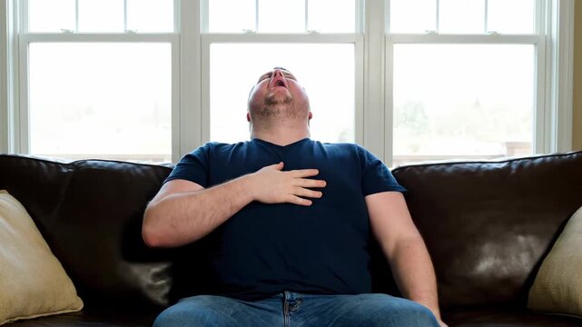 The image of an obese man sitting on the sofa and caressing his chest, the man's sofa is exaggerated and coughing