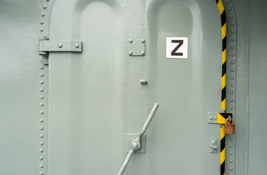 Heavy-duty metal hatch on a military vessel with secure locking system