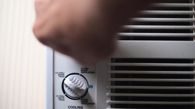 air condition full on cold, setting the nub to full cold, close up on the nub selective focus video, summer heat wave theme