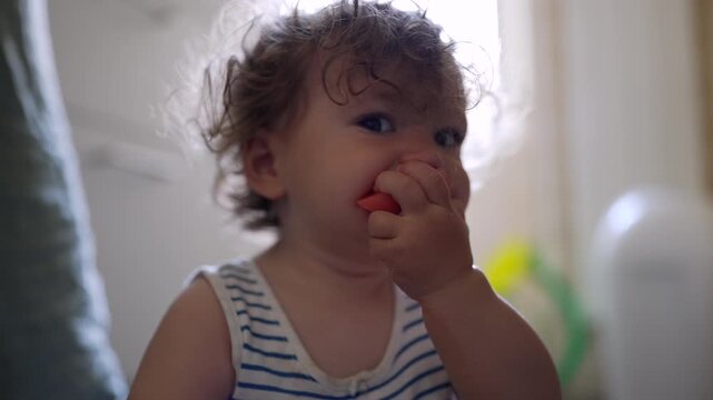 Toddler eating melon at home, highlighting healthy nutrition, self feeding and early childhood development
