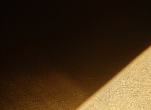 Dramatic reflected light beam on the corner of the room wall abstract