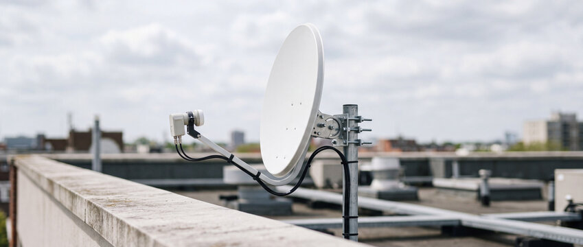 Satellite dish on rooftop antenna providing urban connectivity and wireless communication technology
