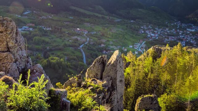 View from rock to town of Smolyan with meadows for cattle walking and houses between mountain range of Rhodope Mountains