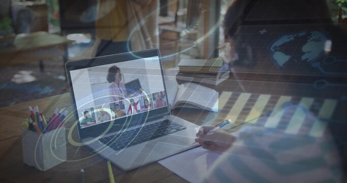 Child writing notes as teacher speaking on laptop for class, globe map overlaying child and laptop