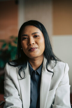 Portrait of smiling confident female business entrepreneur with long hair