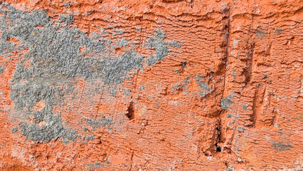 Rough red brick surface exhibiting an aged weathered texture with irregular patterns and embedded gray mortar fragments, providing a sturdy background © Newleks