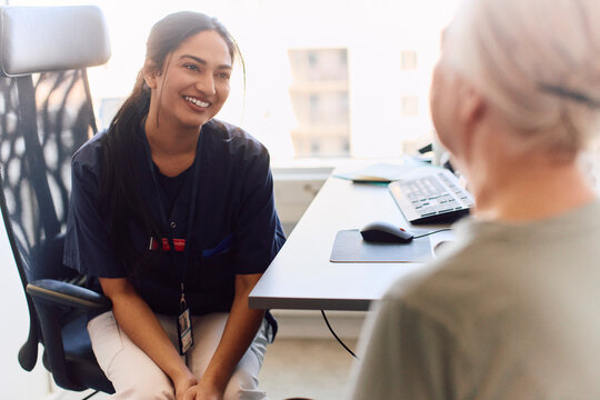 Smiling female doctor sharing good news with senior woman after her checkup