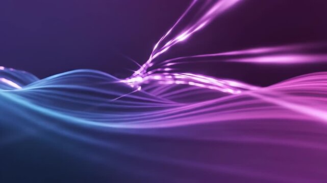 Abstract flowing light streaks in purple and blue hues with a dark background.