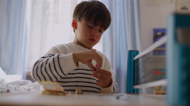 Boy organizing coins in bedroom, highlighting childhood learning, counting skills and independent responsibility at home