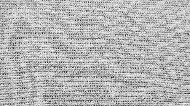 textured white knitted fabric surface filling the cinematic frame with subtle shadows showcasing slow mindful living