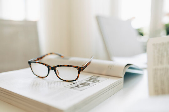 Reading glass and book on table at retirement home