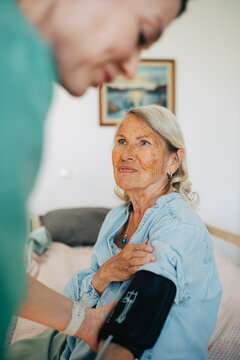 Elderly woman getting her vitals checked at nursing home