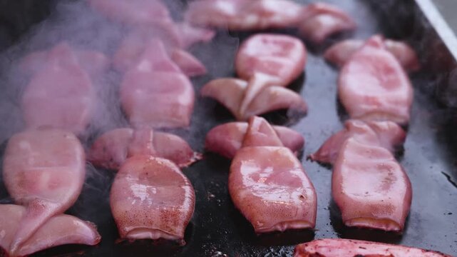 Ikayaki, Grilled roasted Squid with sauce - popular Japanese Street Food, variety of different traditional food snack selection in Tokyo, Japan, street market with local vendor stalls cooking