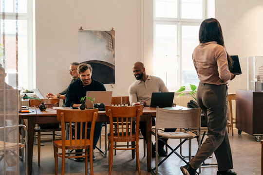 Group of entrepreneurs managing their tasks while working at modern coworking space