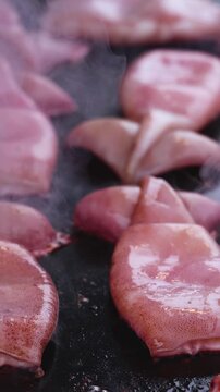 Ikayaki, Grilled roasted Squid with sauce - popular Japanese Street Food, variety of different traditional food snack selection in Tokyo, Japan, street market with local vendor stalls cooking