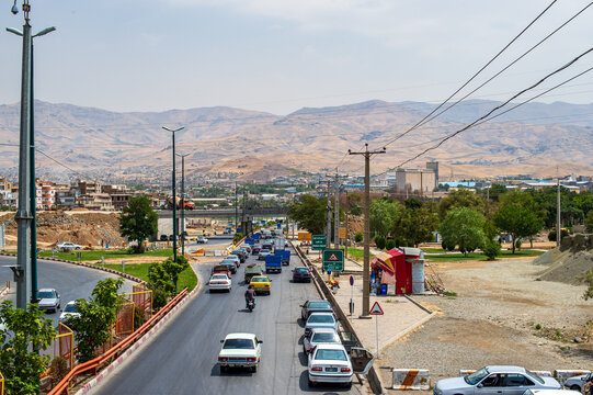 Road Traffic on Qazvin Suburban Highway with Desert Mountains Background, Iran
