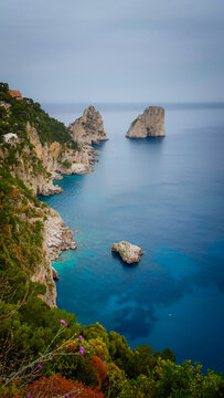 Rocky coastline of Capri Island with crystal-clear turquoise water, breathtaking Mediterranean seascape, dramatic cliffs and pristine coastal landscape in Italy