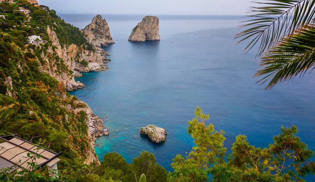 Rocky coastline of Capri Island with crystal-clear turquoise water, breathtaking Mediterranean seascape, dramatic cliffs and pristine coastal landscape in Italy