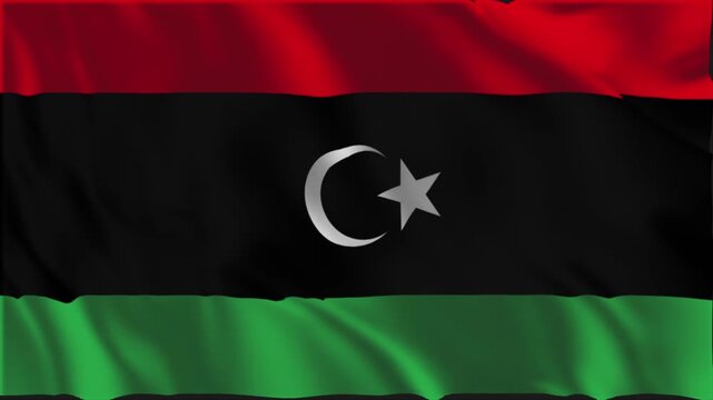 Flag of Libya waving slowly in the foreground.