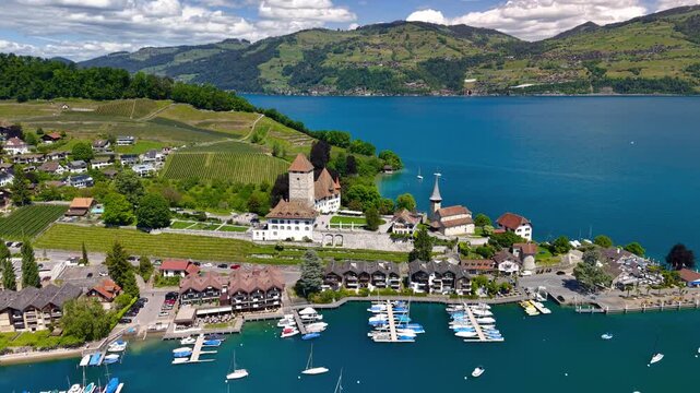 Aerial orbiting Spiez Castle on Lake Thun in Switzerland