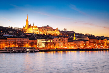 Fototapeta premium Sunset over Budapest skyline with Matthias Church, Fisherman's Bastion, and Danube River, Hungary