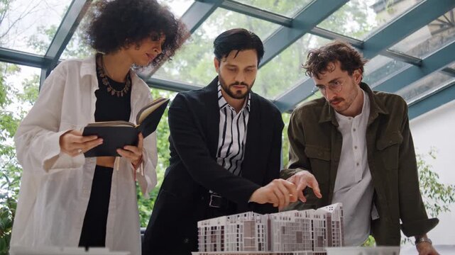 Architectural team studies design of residential buildings model